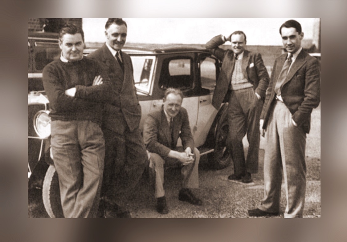 Mutt Summers ( far left) and R J Mitchell (seated) at Eastleigh airfield after the first test flight